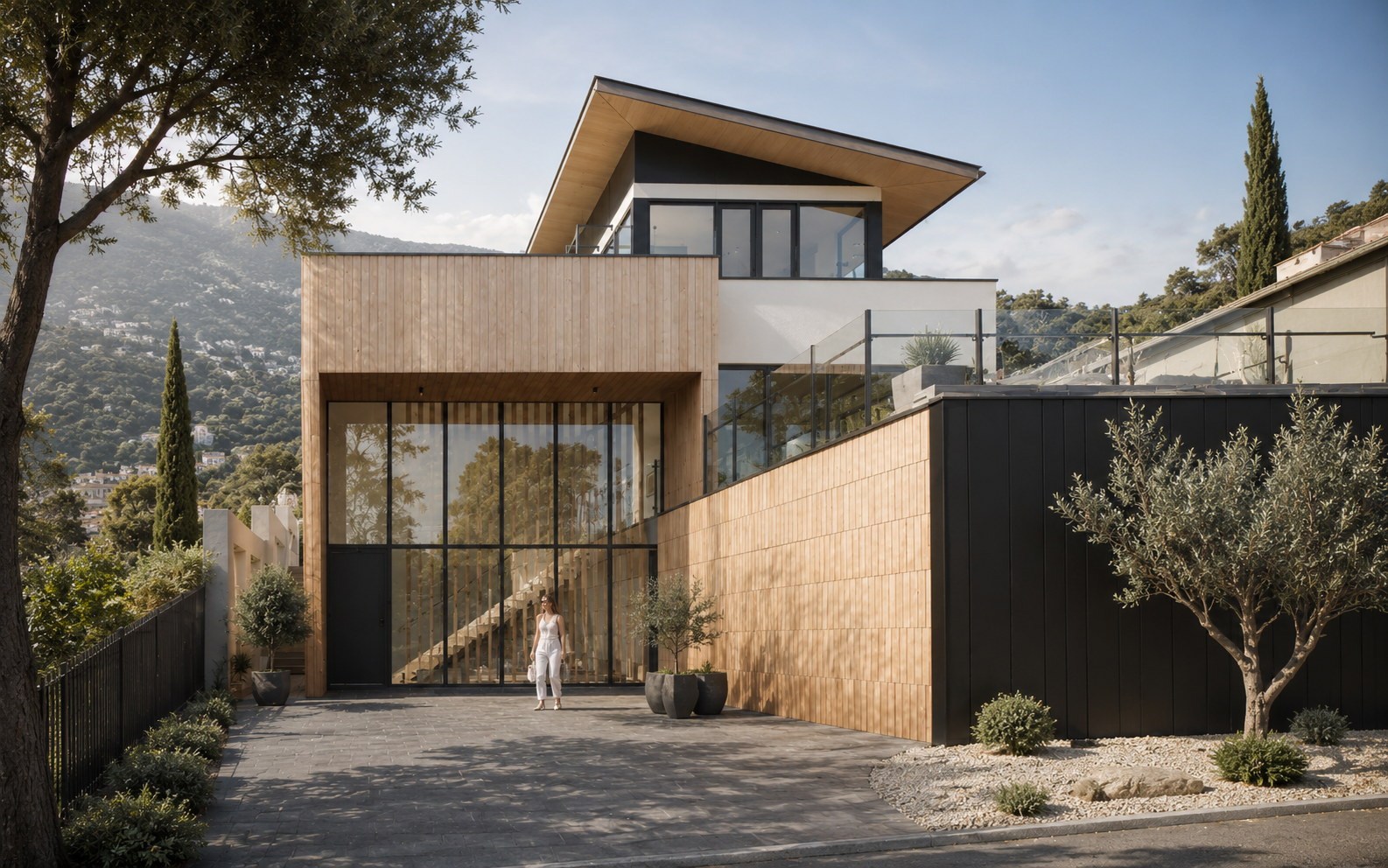 House with timber and dark cladding behind a quiet metal fence