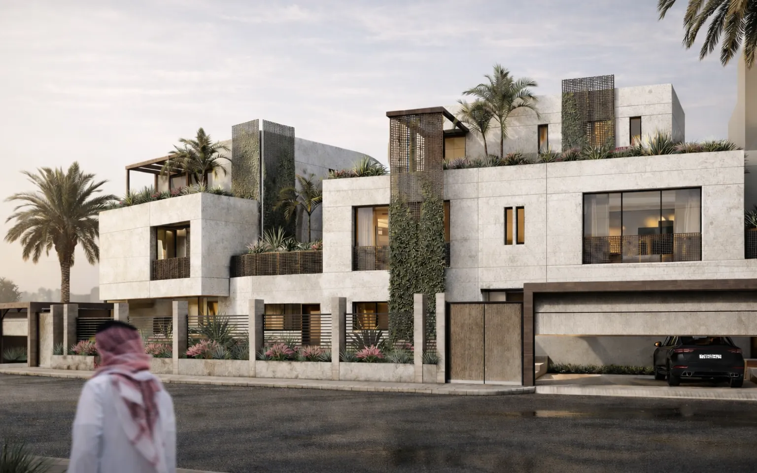 Stone street facade of Montashiri Villa with planted terraces and palms at dusk, Obhur, Jeddah